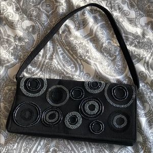 Little black purse with detachable handle.